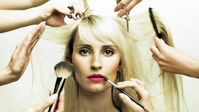 An image of cosmetologists working on a woman