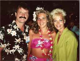 Aloha from a National Convention in Hawaii. John and Elaine pictured below with a happy attendee. 